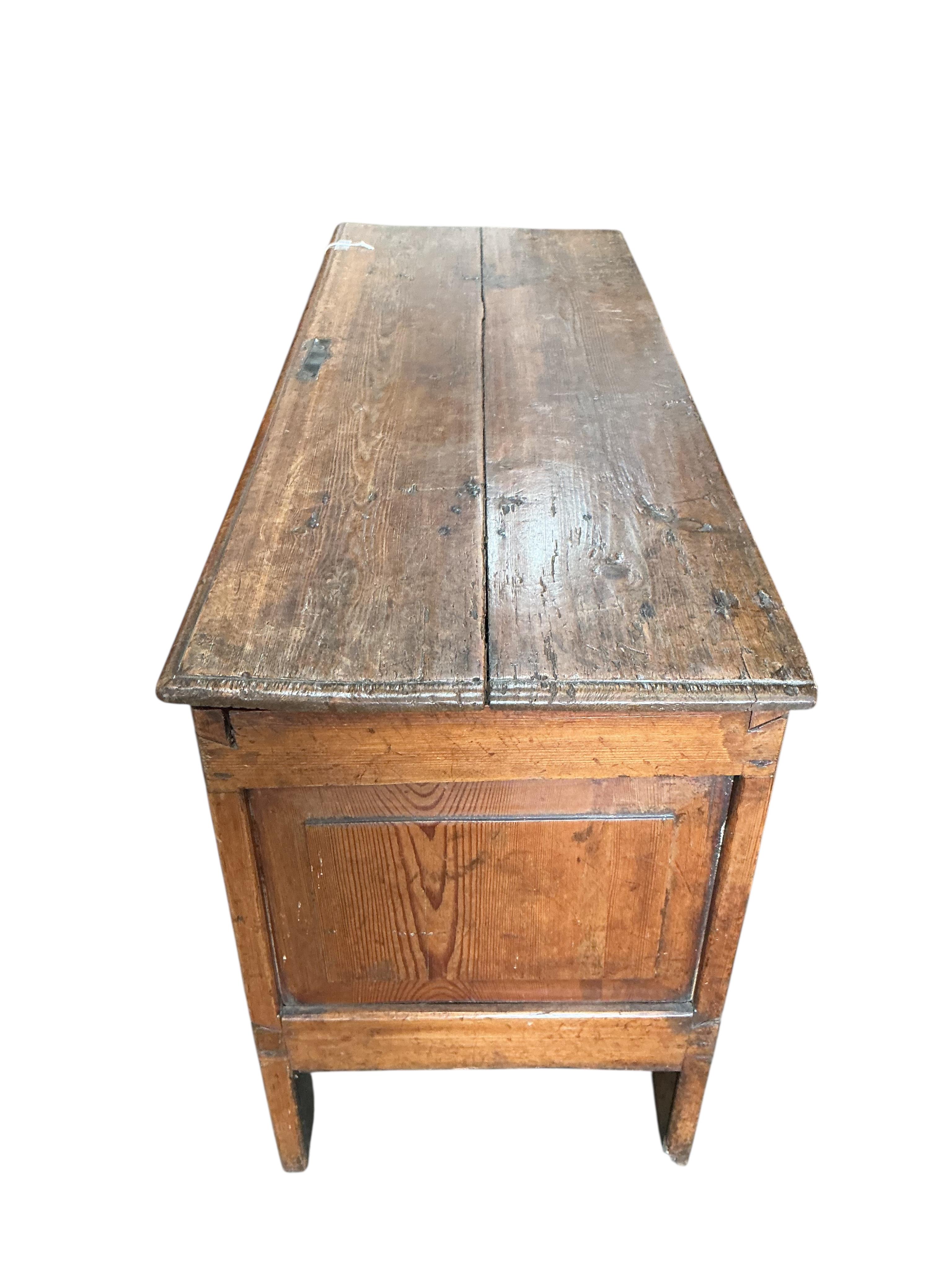 An 18th century panelled pine coffer, width 111cm, depth 42cm, height 62cm